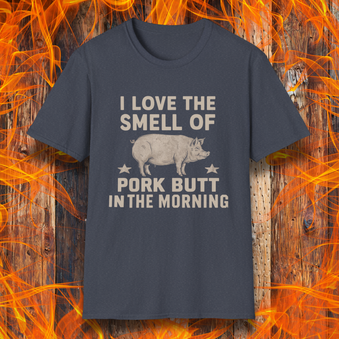 Heather Navy T-shirt with bold beige text reading 'I Love the Smell of Pork Butt in the Morning,' featuring a vintage-style pig illustration and star accents. Perfect for BBQ enthusiasts and pitmasters!