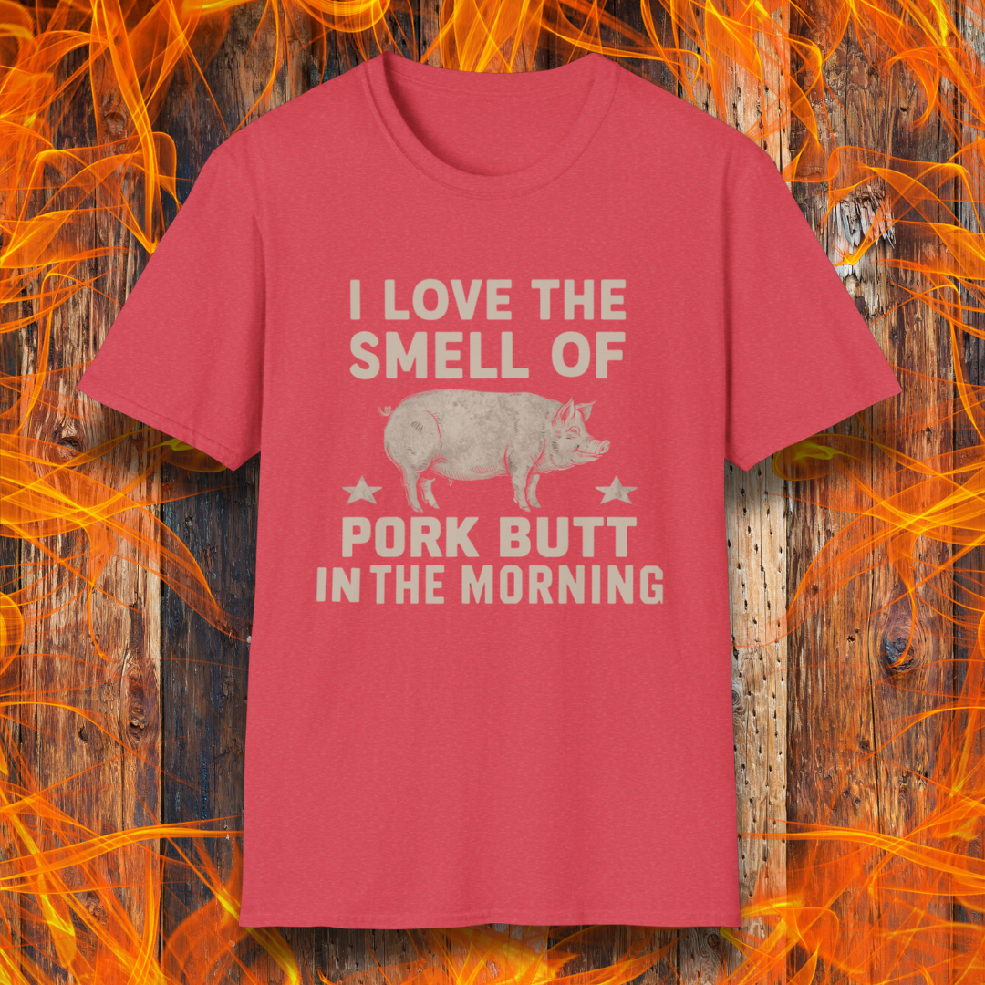 Heather Red T-shirt with bold beige text reading 'I Love the Smell of Pork Butt in the Morning,' featuring a vintage-style pig illustration and star accents. Perfect for BBQ enthusiasts and pitmasters!