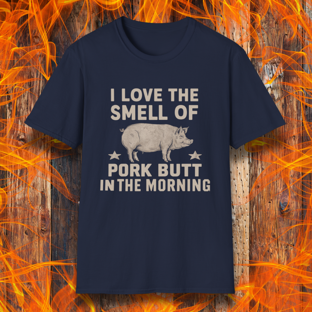 Navy T-shirt with bold beige text reading 'I Love the Smell of Pork Butt in the Morning,' featuring a vintage-style pig illustration and star accents. Perfect for BBQ enthusiasts and pitmasters!