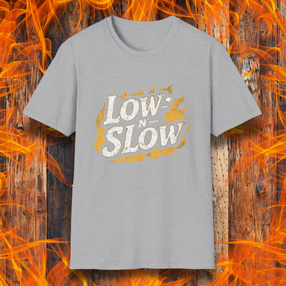 Sport Grey T-shirt featuring 'Low-N-Slow' in bold, distressed lettering over a fiery background. Perfect for BBQ pitmasters who know that great barbecue takes time!