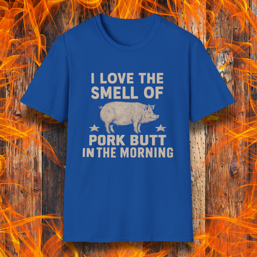 Royal Blue T-shirt with bold beige text reading 'I Love the Smell of Pork Butt in the Morning,' featuring a vintage-style pig illustration and star accents. Perfect for BBQ enthusiasts and pitmasters!