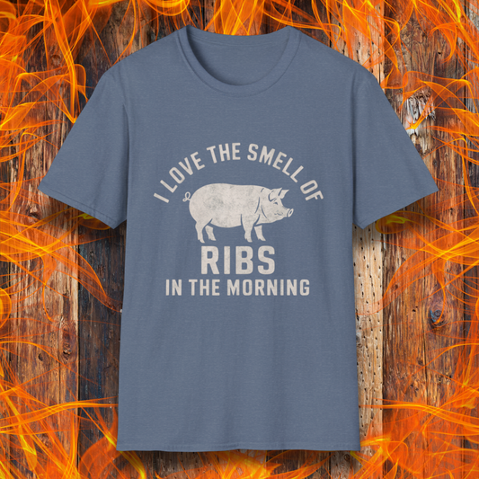 Heather Indigo T-shirt featuring a vintage-style design with the phrase 'I Love the Smell of Ribs in the Morning' and a rustic, hand-drawn pig illustration. Perfect for BBQ pitmasters and rib lovers!