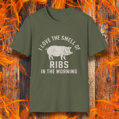 Military Green T-shirt featuring a vintage-style design with the phrase 'I Love the Smell of Ribs in the Morning' and a rustic, hand-drawn pig illustration. Perfect for BBQ pitmasters and rib lovers!