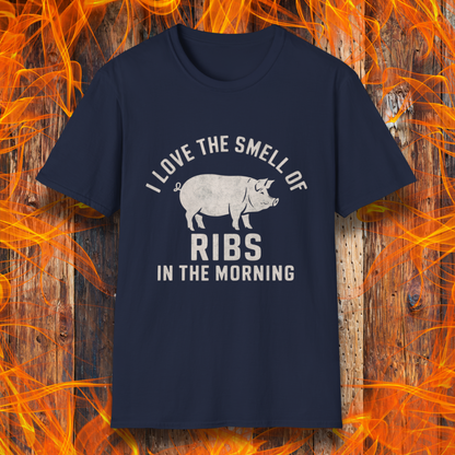 Navy T-shirt featuring a vintage-style design with the phrase 'I Love the Smell of Ribs in the Morning' and a rustic, hand-drawn pig illustration. Perfect for BBQ pitmasters and rib lovers!