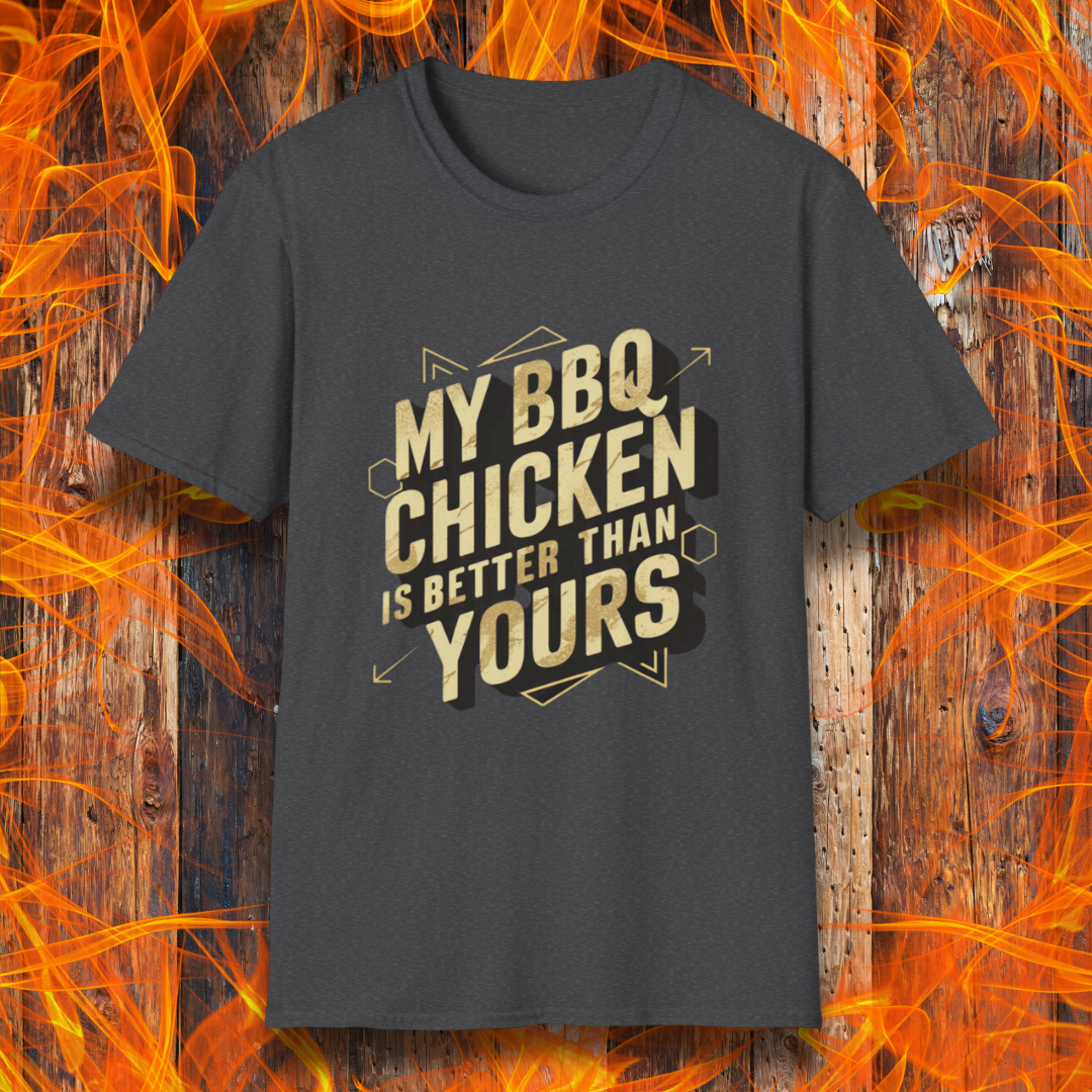 Dark Heather T-shirt featuring a bold BBQ-themed design that reads 'MY BBQ CHICKEN IS BETTER THAN YOURS' in gold and black block lettering with geometric accents. A great choice for grill masters who take pride in their perfectly smoked and seasoned chicken.