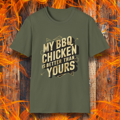 Military Green T-shirt featuring a bold BBQ-themed design that reads 'MY BBQ CHICKEN IS BETTER THAN YOURS' in gold and black block lettering with geometric accents. A great choice for grill masters who take pride in their perfectly smoked and seasoned chicken.