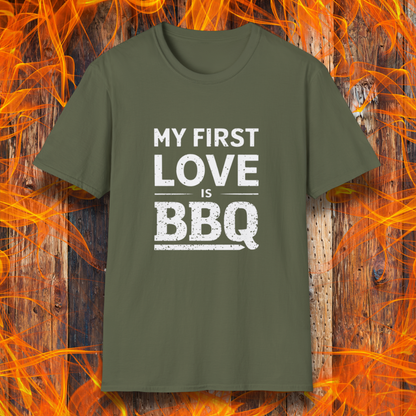Military Green T-shirt with 'My First Love Is BBQ' in bold, distressed white lettering. A must-have for BBQ enthusiasts who wear their passion on their sleeve—literally!