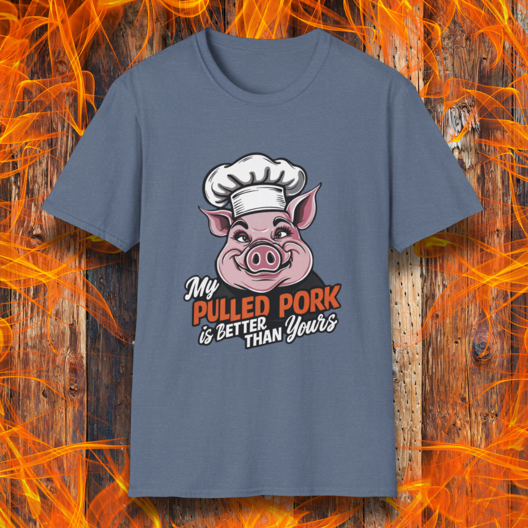Heather Indigo T-shirt featuring a fun BBQ-themed design with a pink cartoon pig wearing a chef’s hat. The bold text reads 'My Pulled Pork is Better Than Yours' in a mix of white and red script and block lettering. Perfect for pitmasters who take pride in their slow-cooked pulled pork."
