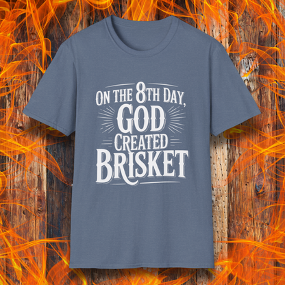 Heather Indigo t-shirt with bold white lettering that declares “On the 8th Day, God Created Brisket.” A divine pick for pitmasters who treat smoked meat like gospel.