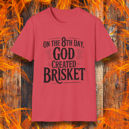 Heather Red t-shirt with bold black lettering that declares “On the 8th Day, God Created Brisket.” A divine pick for pitmasters who treat smoked meat like gospel.