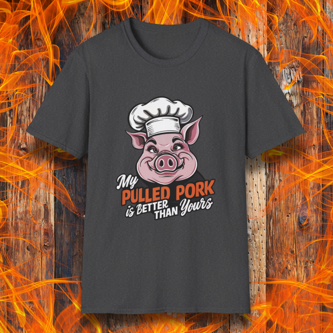 Dark Heather T-shirt featuring a fun BBQ-themed design with a pink cartoon pig wearing a chef’s hat. The bold text reads 'My Pulled Pork is Better Than Yours' in a mix of white and red script and block lettering. Perfect for pitmasters who take pride in their slow-cooked pulled pork."