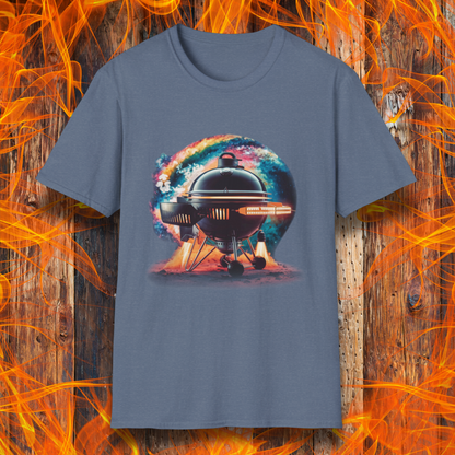 Heather Indigo T-shirt featuring a futuristic BBQ kettle grill designed like a rocket ship, with glowing thrusters, steam, and a cosmic background. A perfect design for BBQ lovers with a passion for sci-fi and grilling.