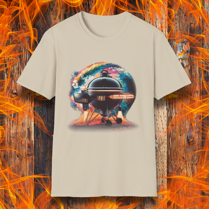Sand T-shirt featuring a futuristic BBQ kettle grill designed like a rocket ship, with glowing thrusters, steam, and a cosmic background. A perfect design for BBQ lovers with a passion for sci-fi and grilling.