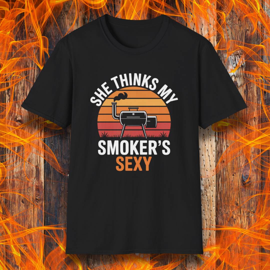 Black t-shirt with graphic design and text on a wooden background with flames.