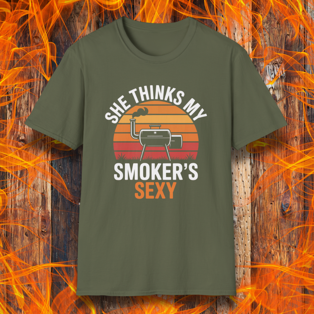 Green t-shirt with graphic design and text on a wooden background with flames.