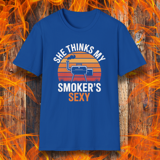 Blue t-shirt with graphic design and text on a wooden background with flames.