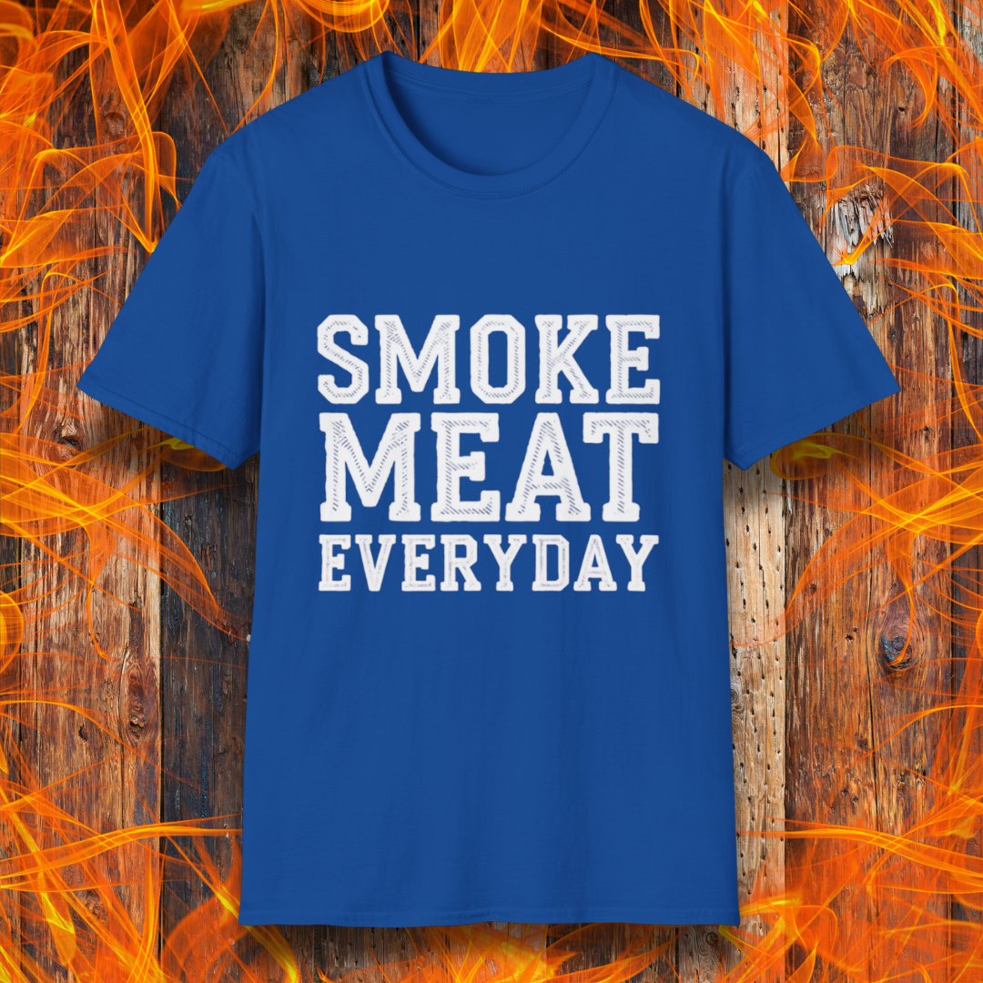 Royal Blue T-shirt featuring bold, white, distressed-text lettering that reads "SMOKE MEAT EVERYDAY." The shirt is displayed against a fiery wooden background, reinforcing the BBQ and grilling theme.
