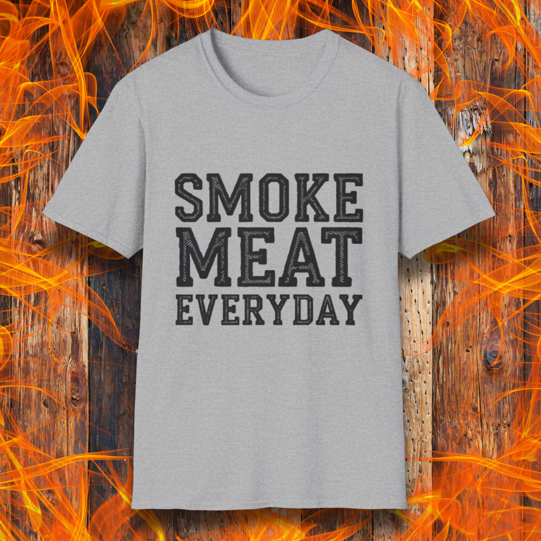 Sport Grey T-shirt featuring bold, white, distressed-text lettering that reads "SMOKE MEAT EVERYDAY." The shirt is displayed against a fiery wooden background, reinforcing the BBQ and grilling theme.