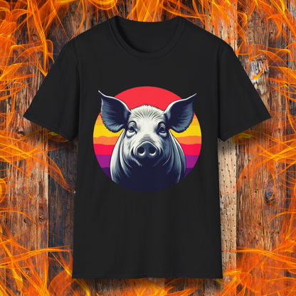Black T-shirt featuring a striking illustration of a pig's face in a bold, high-contrast style, set against a circular sunset background with vibrant red, orange, and purple hues. The design gives a rustic yet modern feel, making it an excellent choice for BBQ lovers.