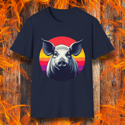Navy T-shirt featuring a striking illustration of a pig's face in a bold, high-contrast style, set against a circular sunset background with vibrant red, orange, and purple hues. The design gives a rustic yet modern feel, making it an excellent choice for BBQ lovers.