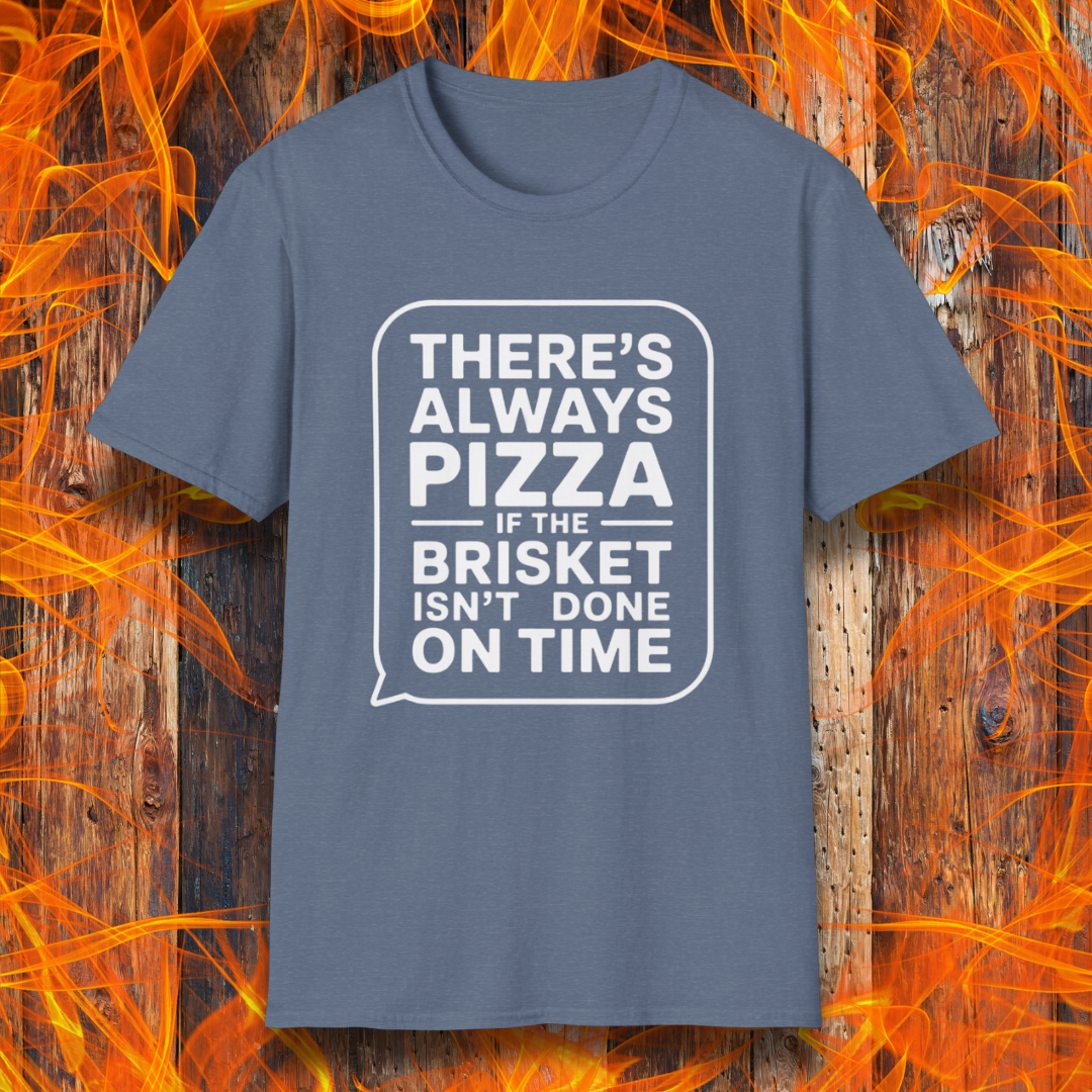 Heather IndigoT-shirt featuring bold white text in a speech bubble that reads "There’s Always Pizza If the Brisket Isn’t Done on Time," displayed over a wooden background with flames — a humorous shirt for BBQ fans who know the struggle of low-and-slow cooking.