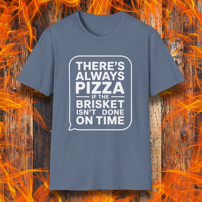 Heather IndigoT-shirt featuring bold white text in a speech bubble that reads "There’s Always Pizza If the Brisket Isn’t Done on Time," displayed over a wooden background with flames — a humorous shirt for BBQ fans who know the struggle of low-and-slow cooking.