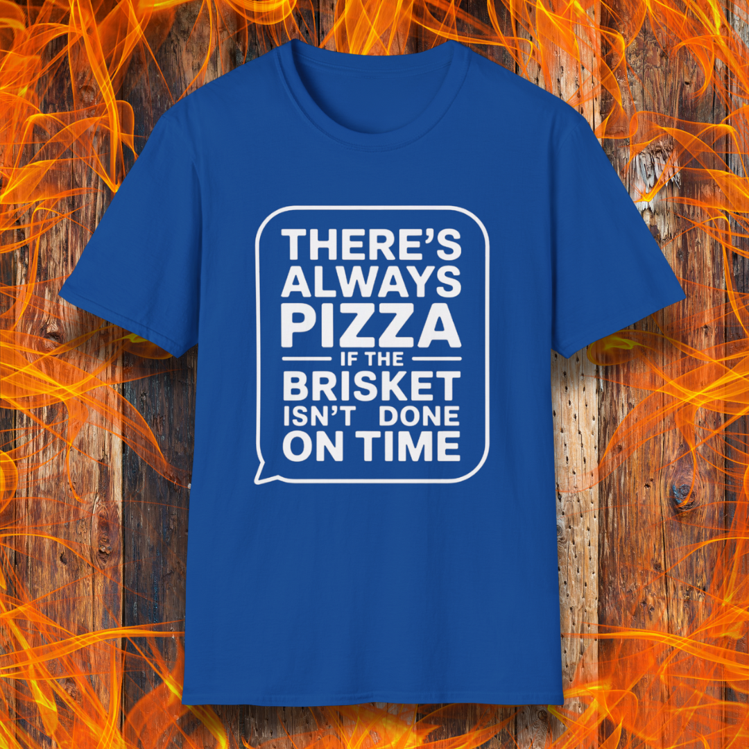 Royal Blue T-shirt featuring bold white text in a speech bubble that reads "There’s Always Pizza If the Brisket Isn’t Done on Time," displayed over a wooden background with flames — a humorous shirt for BBQ fans who know the struggle of low-and-slow cooking.
