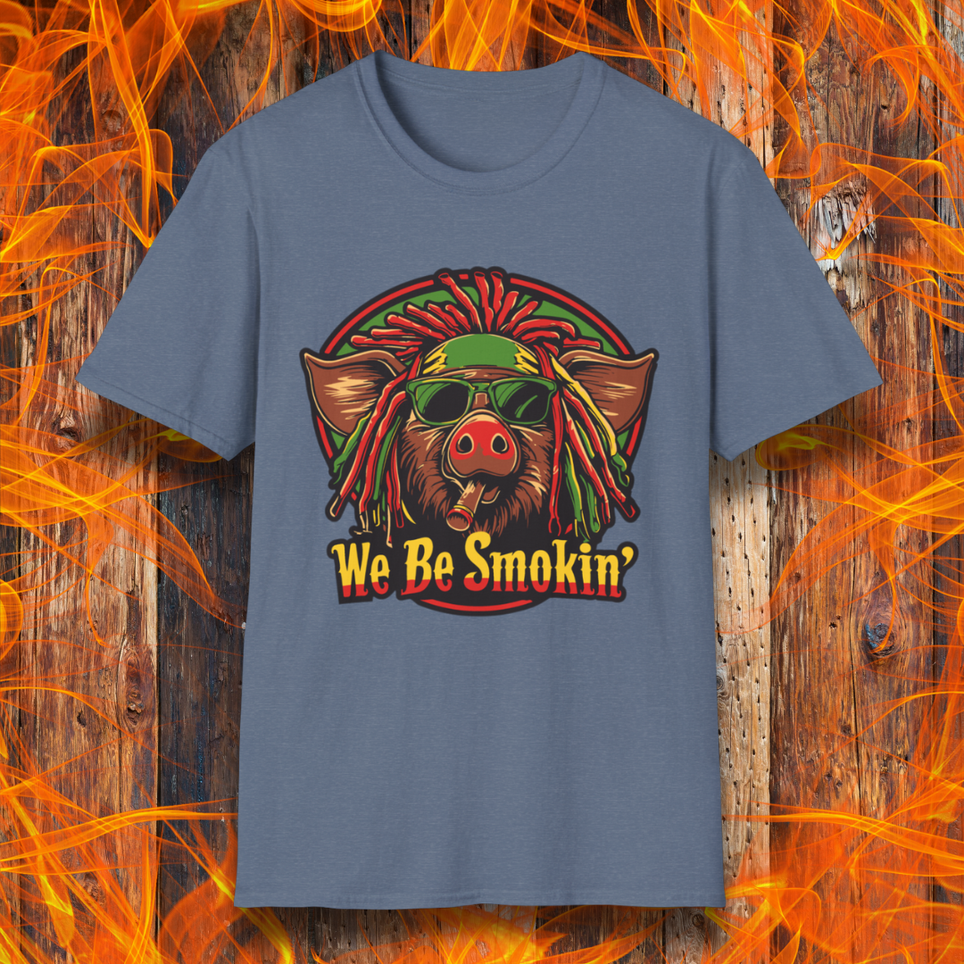 Heather Indigo T-shirt featuring a cool, reggae-inspired pig with dreadlocks, sunglasses, and a cigar, with the phrase 'We Be Smokin’' in bold, fiery lettering. A must-have for BBQ lovers who like to keep it chill while grilling!