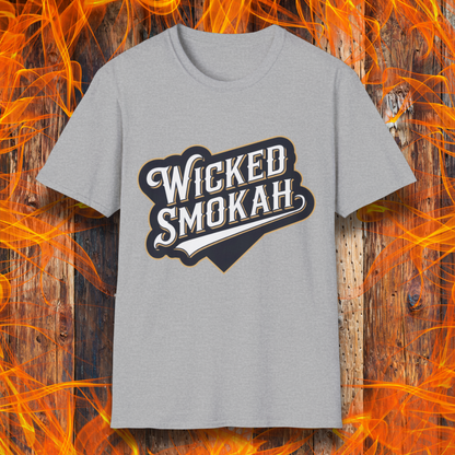 Sport Grey T-shirt featuring a bold, vintage-style design that reads "Wicked Smokah" in stylized typography, resembling a sports team logo. The lettering has a mix of white and gold outlines, giving it a classic and rugged look. The shirt is displayed against a fiery wooden background, reinforcing the smoky BBQ theme.